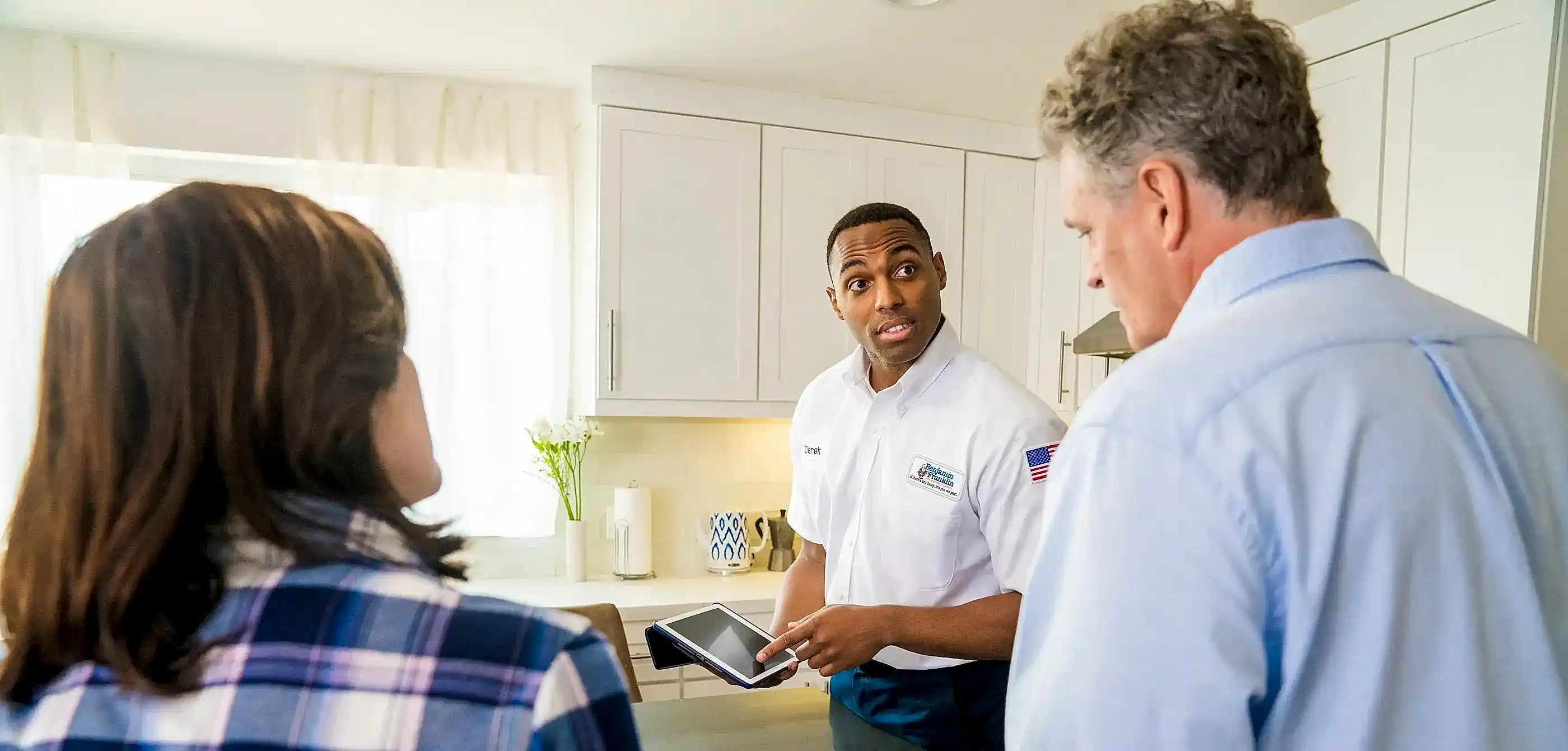 Benjamin Franklin Plumbing technician helping clients